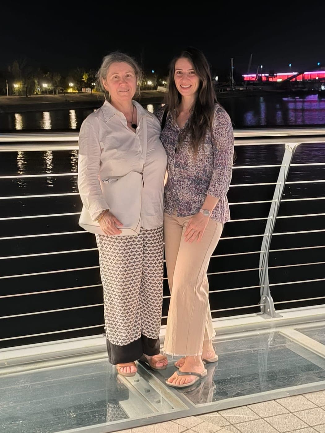 Me and my mom, traveling together at night by the water